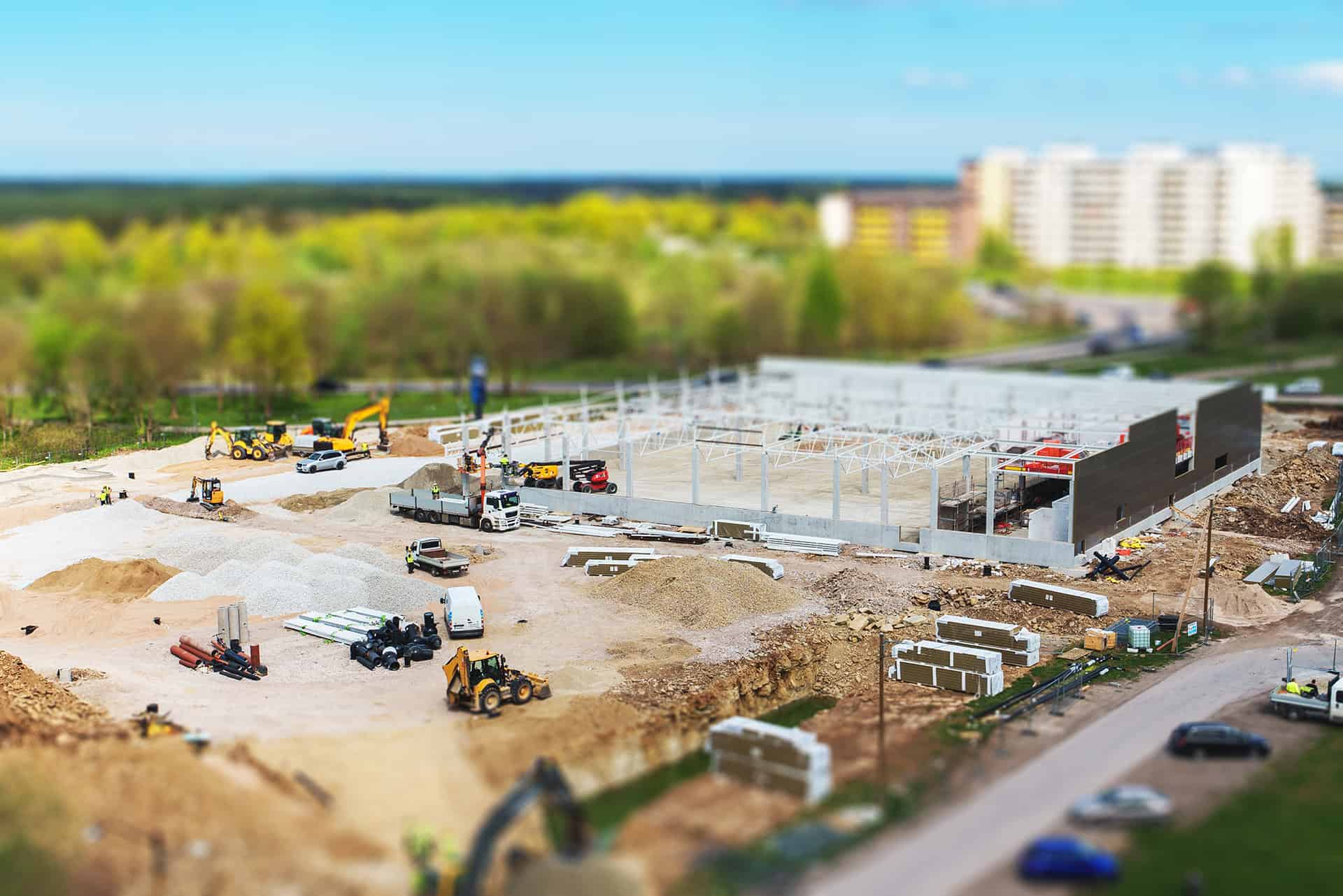 Construction site with steel framework and heavy machinery in progress.