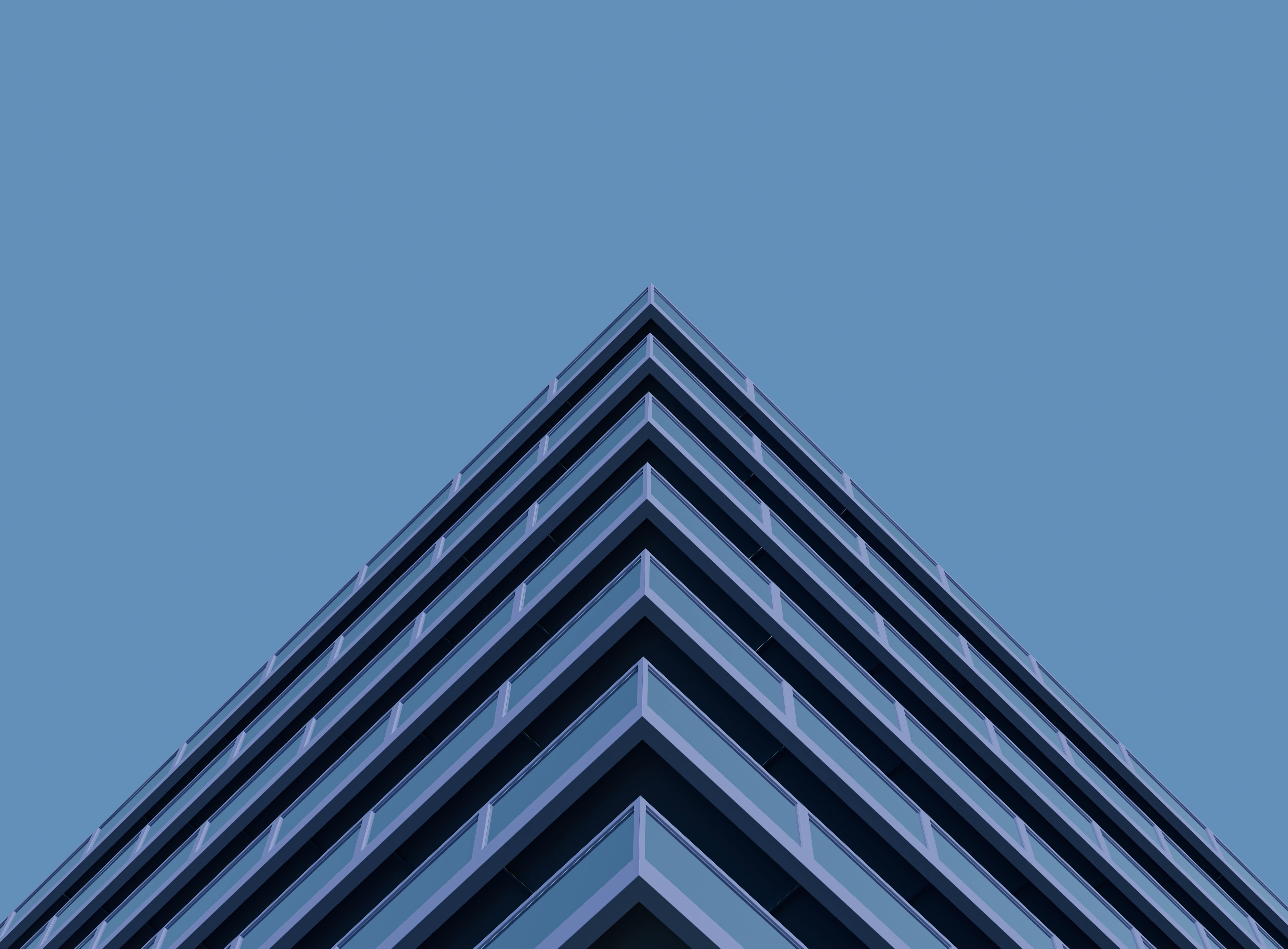 Contemporary office building with sharp angles and glass facade.