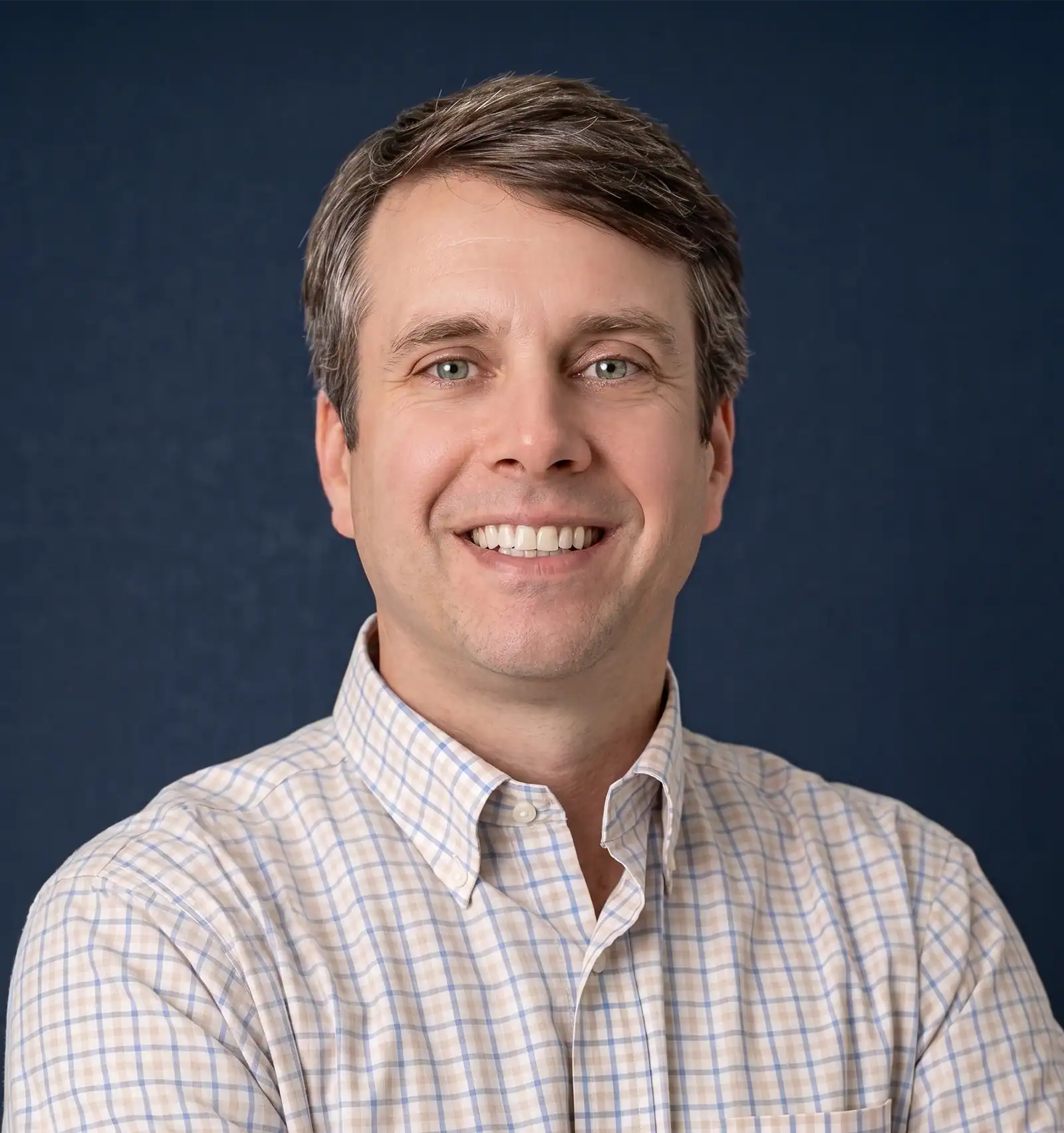 Professional man smiling in a business portrait for leadership themes.
