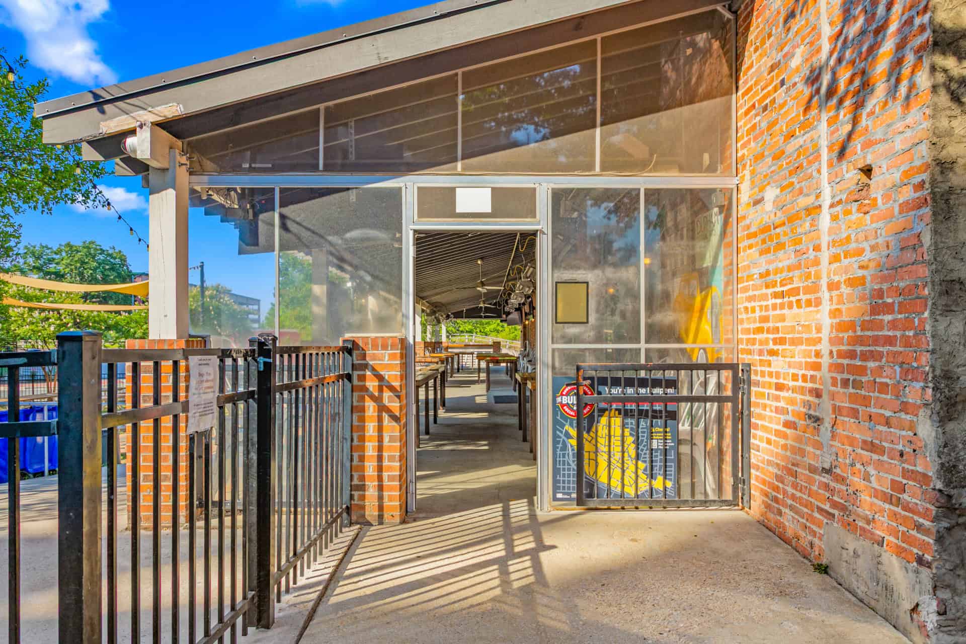 Modern pub entrance with glass doors and brick walls at Incline Construction Inc.