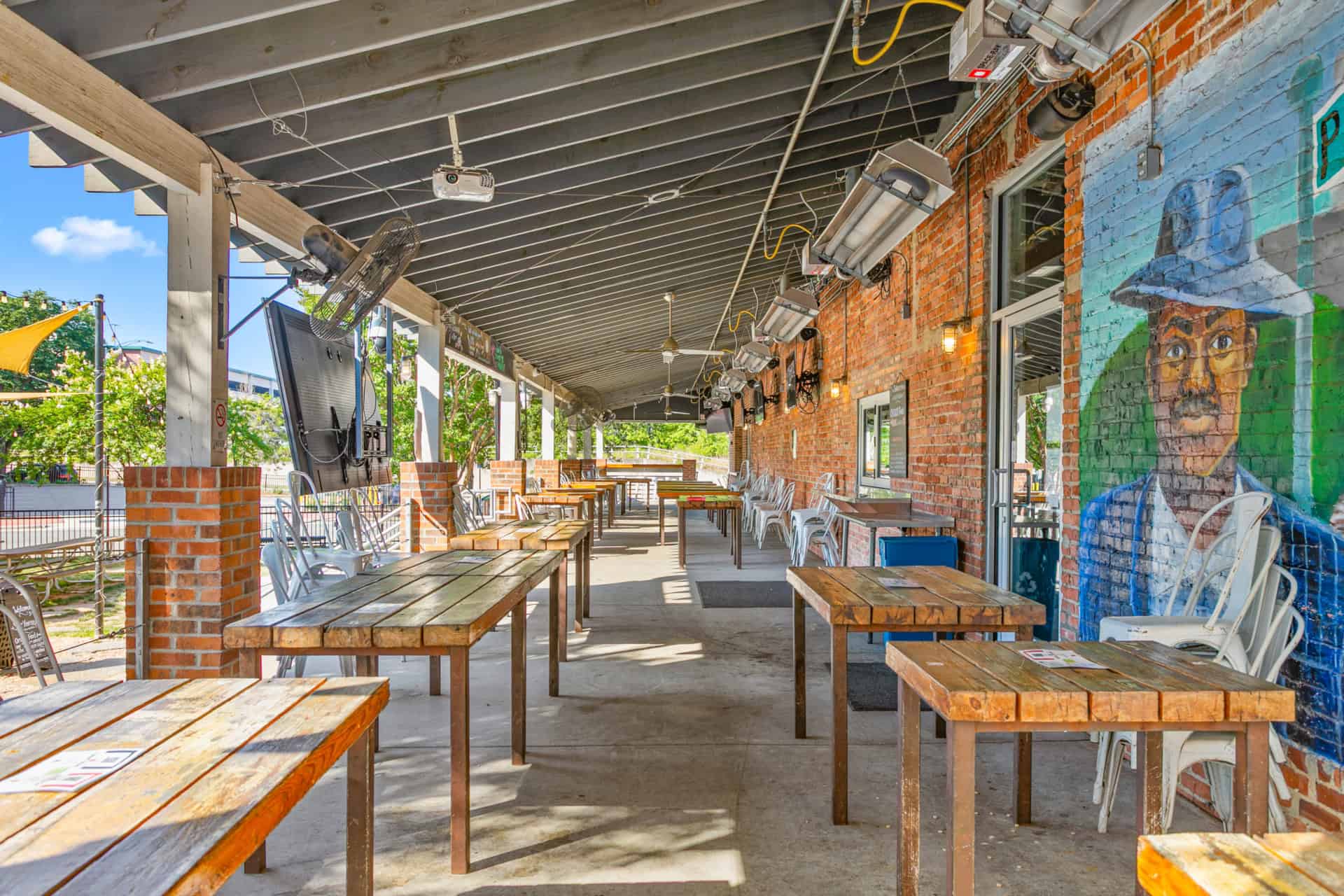 Outdoor patio with wooden tables and chairs at Incline Construction Inc.